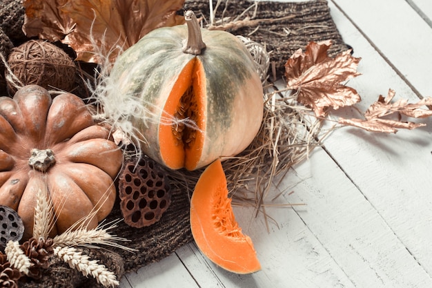 Free photo autumn wall with decorative items and pumpkin.