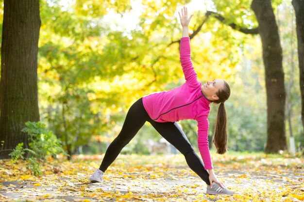 Autumn Yoga outdoors: Extended Triangle pose