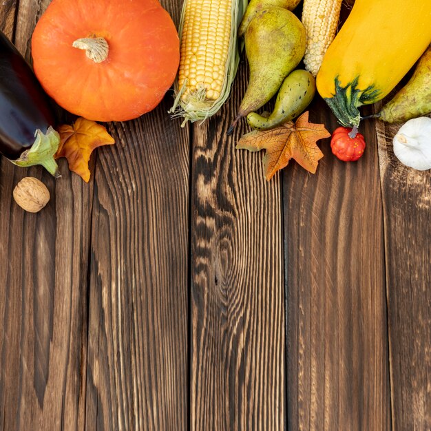 Autumnal frame on wooden background