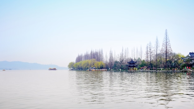 Autumnal landscape with river and leafless trees