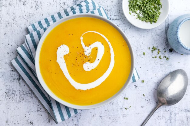 Autumnal soup in bowl on grey background