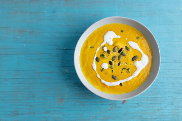 Autumnal soup in bowl on grey background