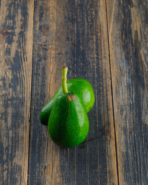 Avocados on a wooden table. top view.