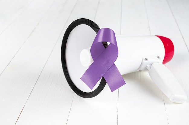 Free photo the awareness campaign in november month. close up light blue ribbon awareness. symbol for support men who living with cancer