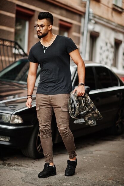 Awesome beautiful tall ararbian beard macho man in glasses and black tshirt walking against business car