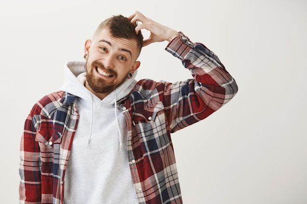 Awkward worried guy make forced smile and looking guilty