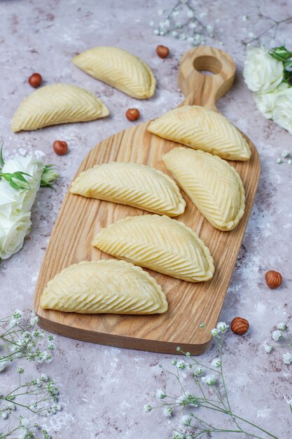 Azerbaijan national pastry shakarbura on white plate on grey concrete  ,top view,spring new year celebration Novruz holiday.