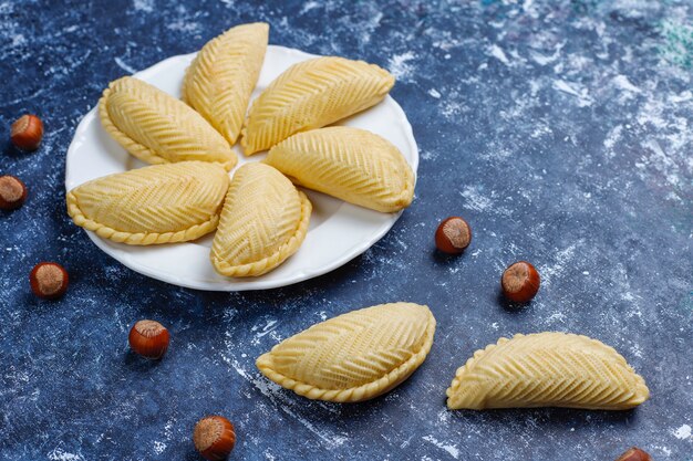 Azerbaijan national pastry shakarbura on white plate  ,top view,spring new year celebration Novruz holiday.