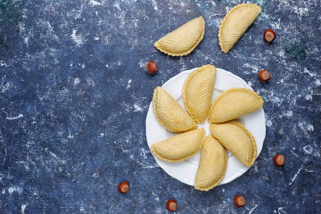 Azerbaijan national pastry shakarbura on white plate  ,top view,spring new year celebration Novruz holiday.