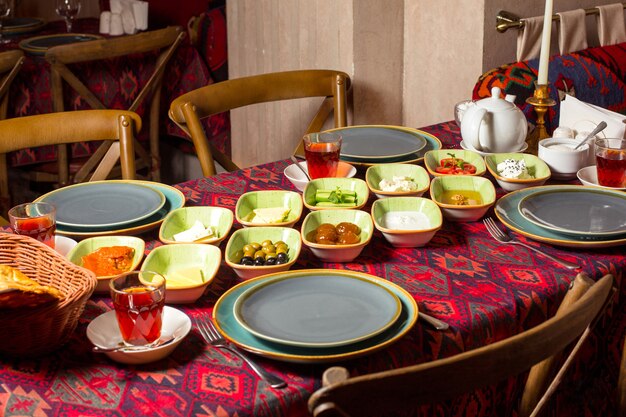 Azerbaijani breakfast layout at the restaurant with traditional style table cloth