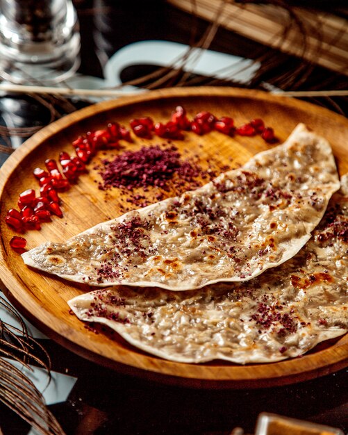 Azerbaijani gutab stuffed flatbread with minced meat topped with sumack