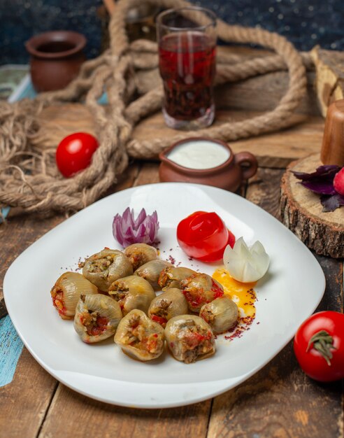 Азербайджанская луковая долма, фаршированная мясом и подается с йогуртом.