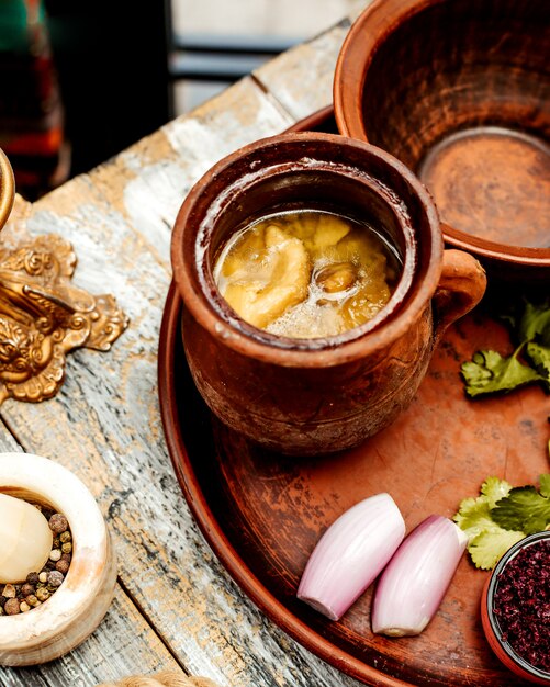 Azeri national piti with lamb fat in a clay pot