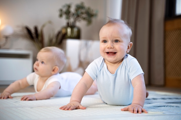 Free photo babies crawling and learning to walk together