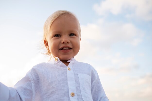 Free photo baby boy on the beach at sunset