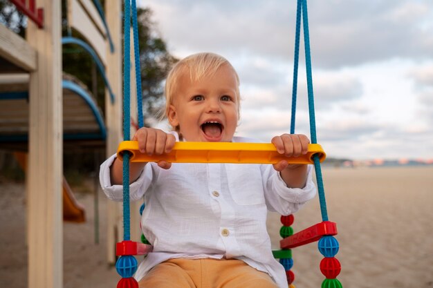 Free photo baby boy on the beach at sunset