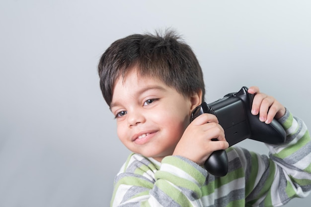 Baby boy gamer with controller in hand