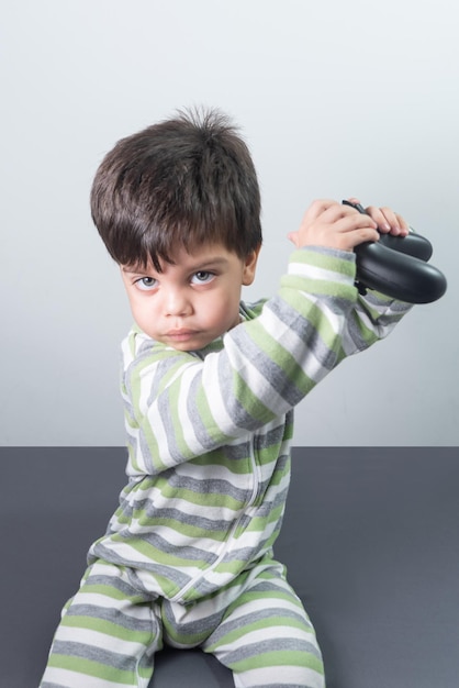 Baby boy gamer with controller in hand