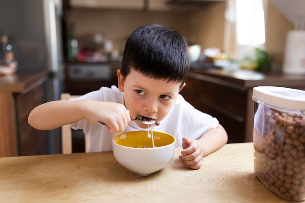 Baby boy having breakfast at home