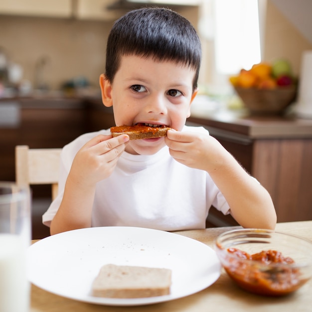 Baby boy having breakfast at home