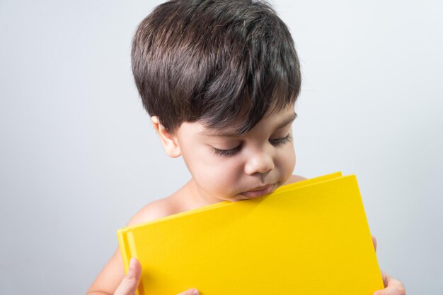 Baby boy holding yellow book