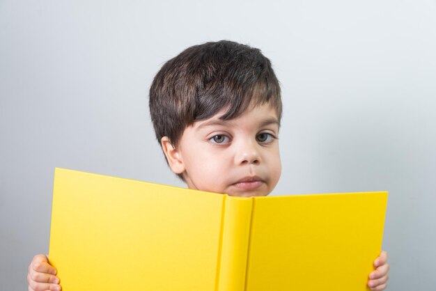 Baby boy reading yellow book