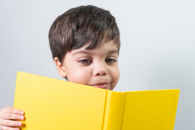 Baby boy reading yellow book