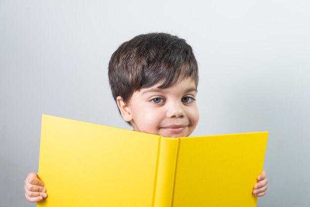Baby boy reading yellow book