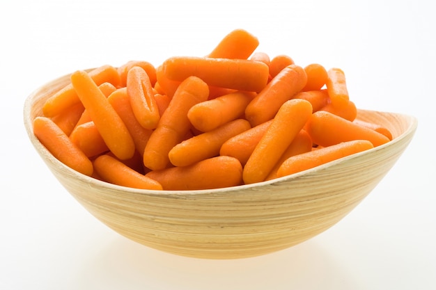 Free photo baby carrot in wooden bowl