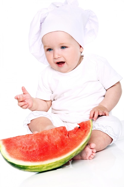Baby chef eating watermelon