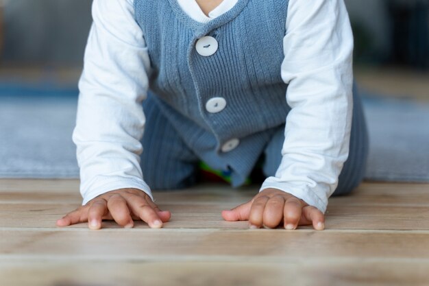 Free photo baby crawling on the floor and learning how to walk