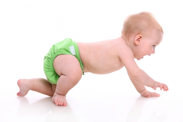 Baby crawling with green diaper