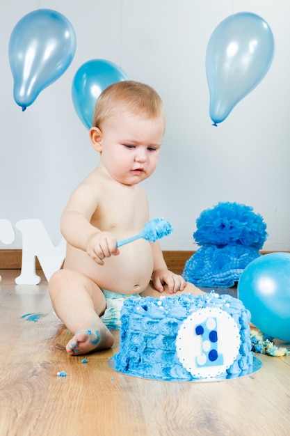 "Baby eating birthday cake. "