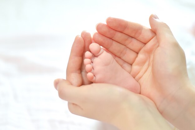 Baby feet in mother hands.