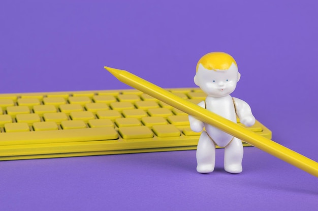 A baby figure with a yellow pencil next to a yellow keyboard on a purple background.