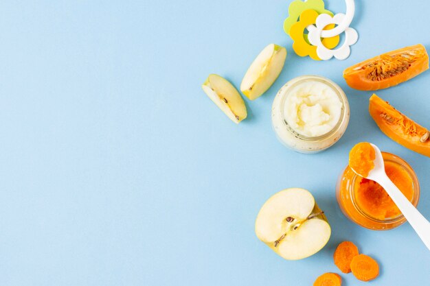 Baby food on blue background flat lay