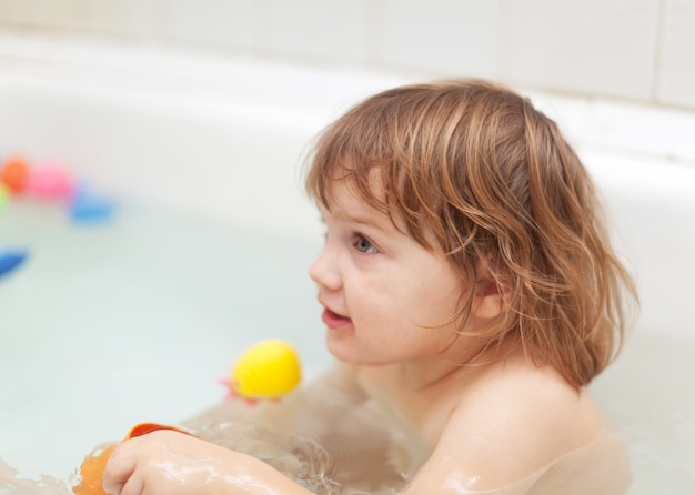 baby girl bathes in bath