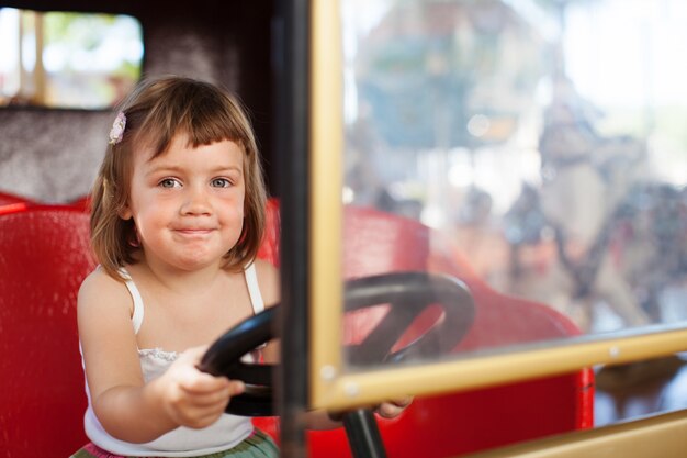 baby girl in carousel