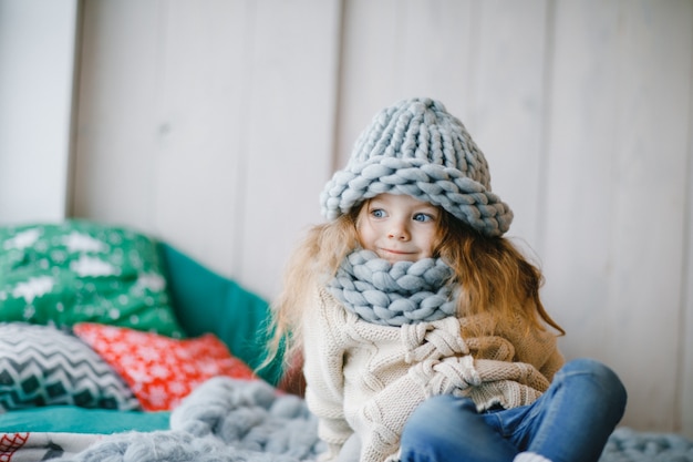 baby girl in knitted hat and scarf