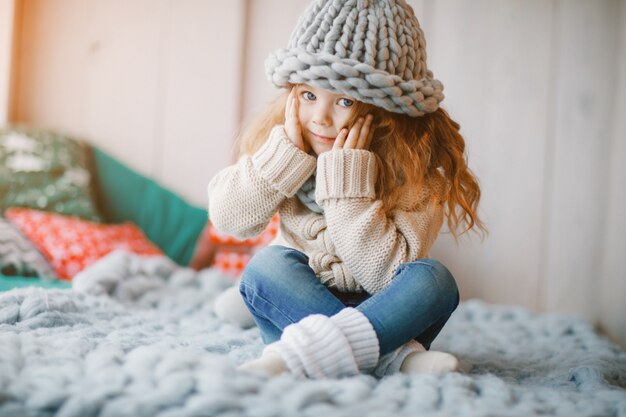 baby girl in knitted hat and scarf