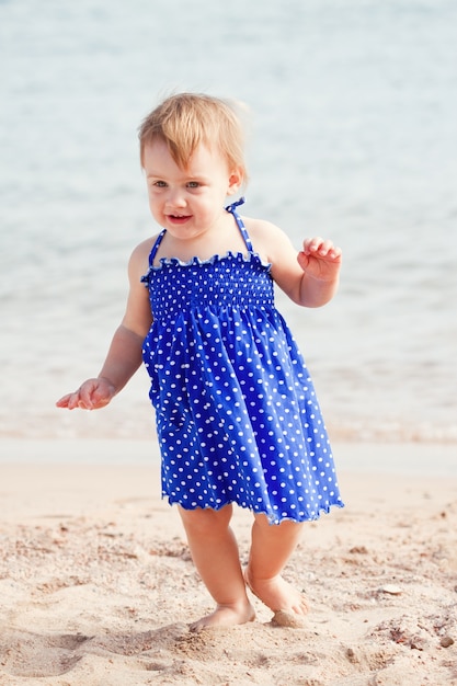 Free photo baby girl  on sand beach