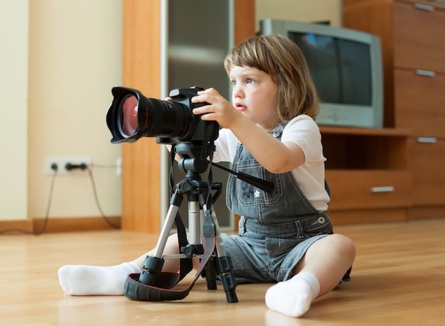 Free photo baby girl takes photo with camera