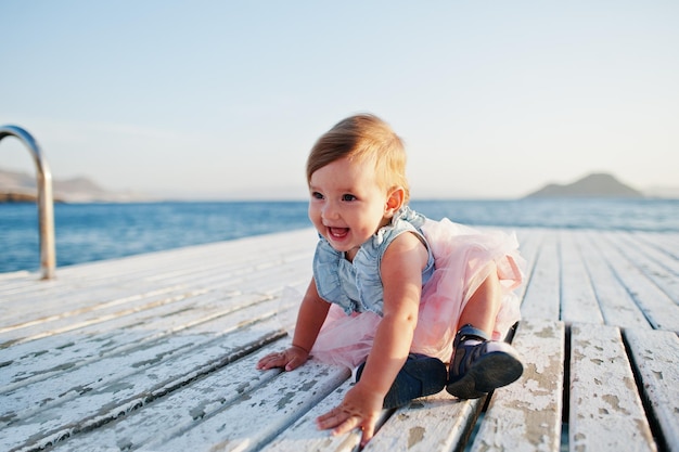 Free photo baby girl at turkey resort on pier against mediterranean sea