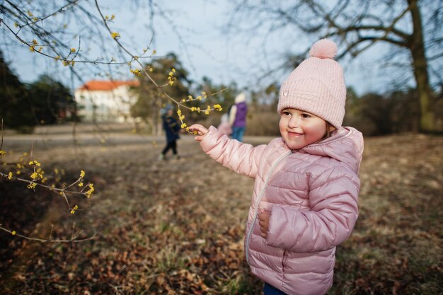 Baby girl wear pink jacket walking at Valtice park Czech Republic