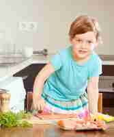 Free photo baby girl with raw salmon fish