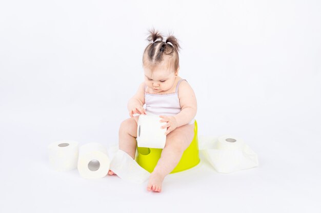 Premium Photo Baby Girl Sits On A Children S Pot Toilet On A White Background