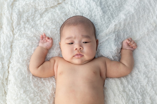 Baby lying on the bed