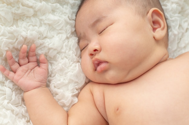 Baby lying on the bed