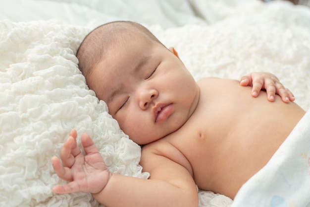 Baby lying on the bed