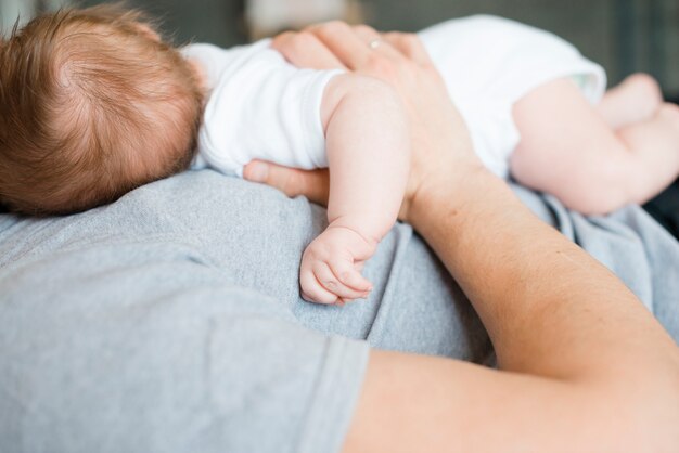 Baby lying on chest of dad